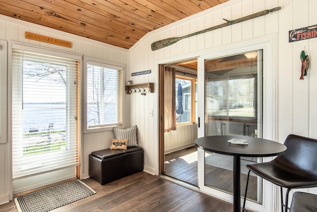 doorway to outside featuring dark wood-type flooring, wood ceiling, baseboards, wood walls, and lofted ceiling