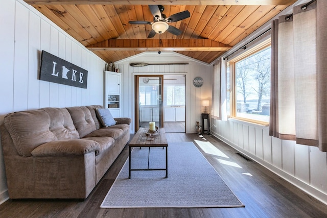 living room featuring plenty of natural light, dark wood-style floors, wood ceiling, wood walls, and ceiling fan