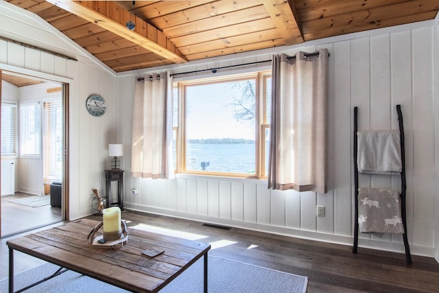 living area with wooden ceiling, wood finished floors, plenty of natural light, wood walls, and baseboards