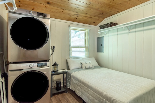 bedroom featuring stacked washing machine and dryer, lofted ceiling, wood finished floors, wood ceiling, and electric panel