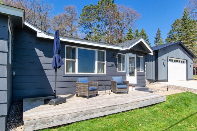 view of front of property featuring an attached garage and a deck