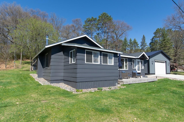 single story home with a garage, a front yard, and concrete driveway