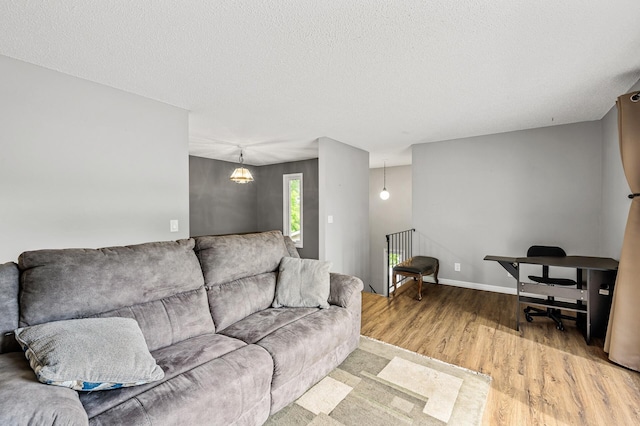 2478 Cobble Hill Alcove Unit C, Woodbury, MN 55125 - living area featuring wood finished floors, a textured ceiling, and baseboards