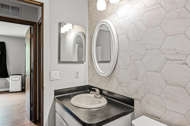 2478 Cobble Hill Alcove Unit C, Woodbury, MN 55125 - bathroom featuring vanity and wood finished floors