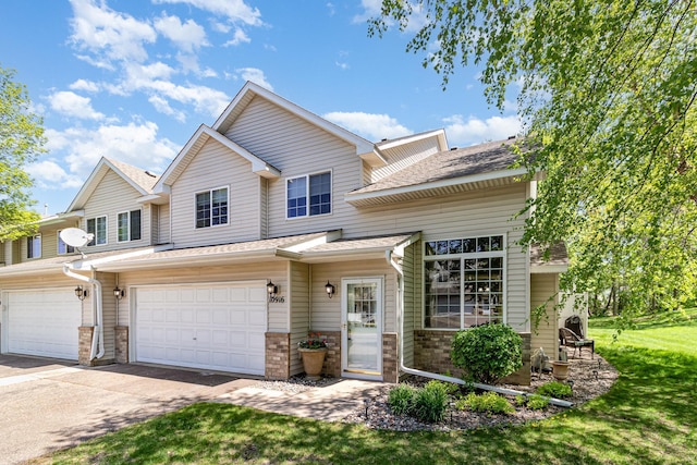 10916 181st Ln NW, Elk River, MN 55330 - multi unit property featuring a garage, concrete driveway, a shingled roof, and a front lawn