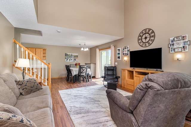 10916 181st Ln NW, Elk River, MN 55330 - living area featuring a chandelier, stairs, wood finished floors, and baseboards