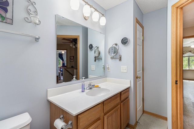 10916 181st Ln NW, Elk River, MN 55330 - bathroom featuring toilet, vanity, and a ceiling fan