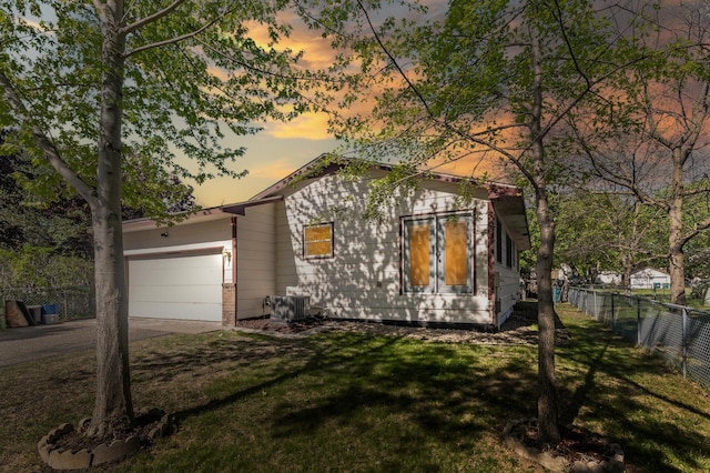 view of front of property with a garage, cooling unit, and driveway