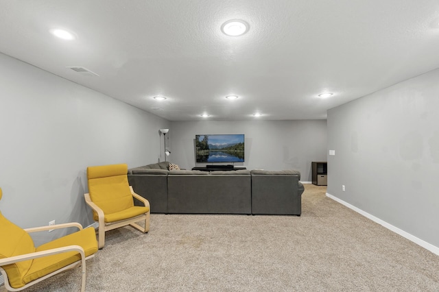 carpeted living area featuring baseboards and recessed lighting
