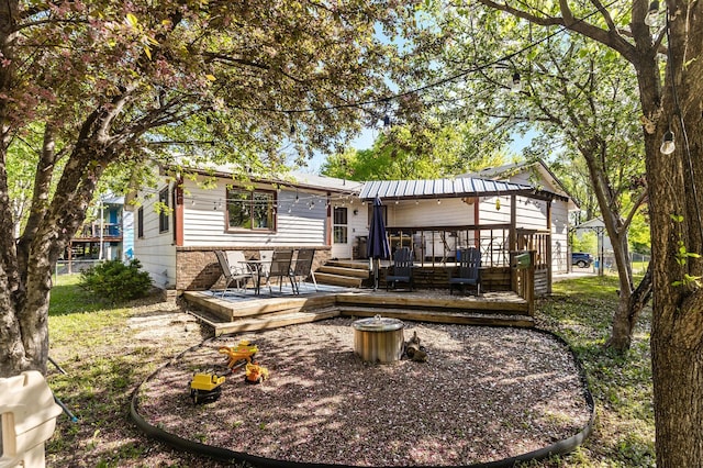 rear view of house with a wooden deck