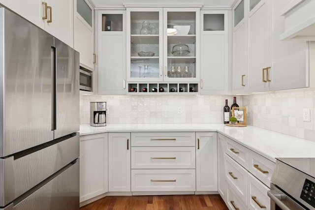501 Main St N Unit 409, Stillwater, MN 55082 - kitchen with stainless steel appliances, white cabinets, decorative backsplash, and light stone countertops