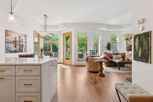 501 Main St N Unit 409, Stillwater, MN 55082 - living area with light wood-style flooring, a chandelier, and baseboards