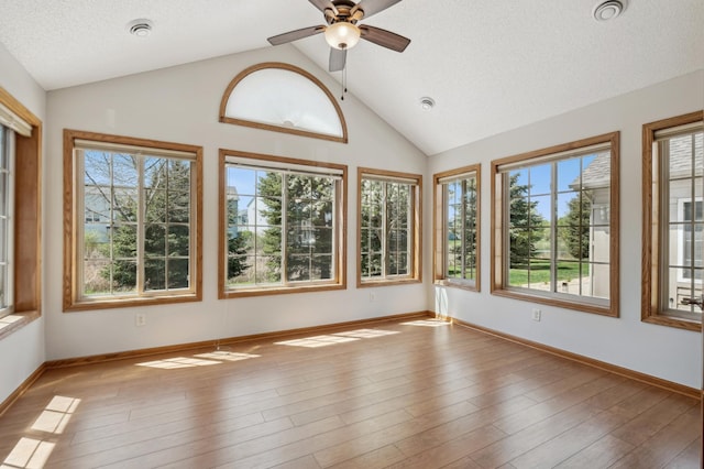24107 Rivers Edge Rd, Rogers, MN 55374 - unfurnished sunroom featuring healthy amount of natural light, vaulted ceiling, baseboards, wood finished floors, and a textured ceiling