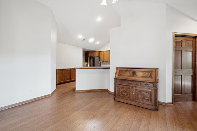 24107 Rivers Edge Rd, Rogers, MN 55374 - unfurnished living room featuring vaulted ceiling, wood-type flooring, and baseboards