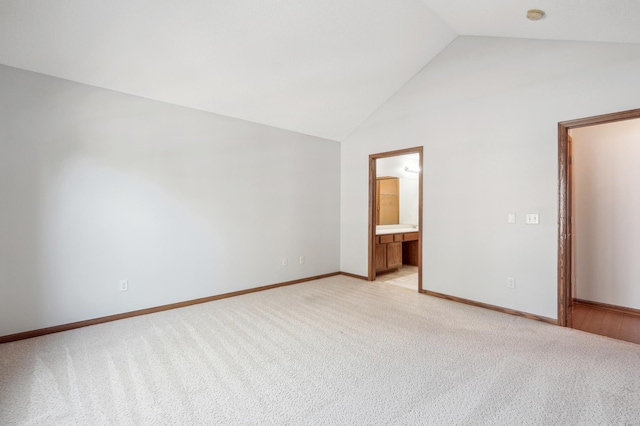 24107 Rivers Edge Rd, Rogers, MN 55374 - unfurnished bedroom with light carpet, baseboards, high vaulted ceiling, and ensuite bath