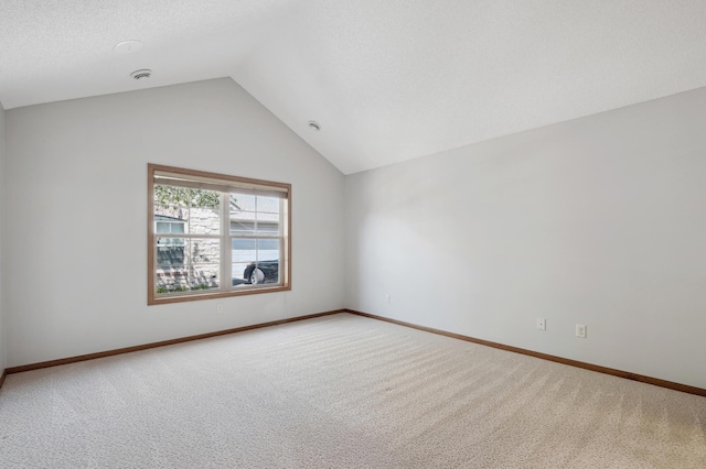 24107 Rivers Edge Rd, Rogers, MN 55374 - empty room featuring carpet flooring, lofted ceiling, and baseboards