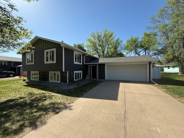 504 Fallwood Rd, Redwood Falls, MN 56283 - tri-level home featuring a garage, concrete driveway, and a front lawn