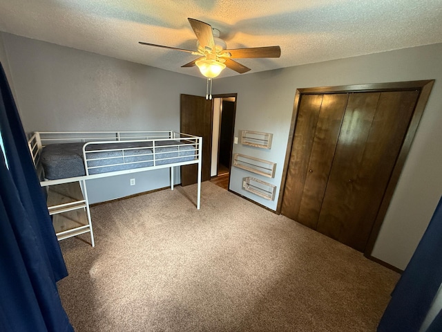 504 Fallwood Rd, Redwood Falls, MN 56283 - carpeted bedroom with a textured ceiling, a closet, and a ceiling fan