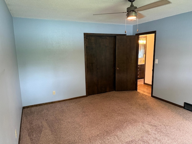 504 Fallwood Rd, Redwood Falls, MN 56283 - unfurnished bedroom featuring light colored carpet, a closet, and ceiling fan