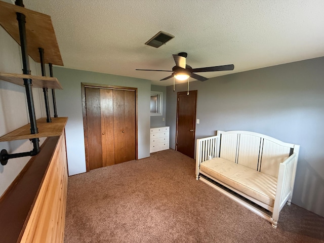 504 Fallwood Rd, Redwood Falls, MN 56283 - bedroom featuring carpet floors, a textured ceiling, a closet, and a ceiling fan