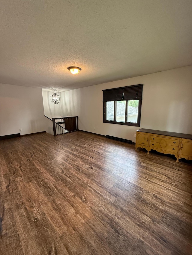 504 Fallwood Rd, Redwood Falls, MN 56283 - spare room with wood finished floors, a textured ceiling, and a chandelier