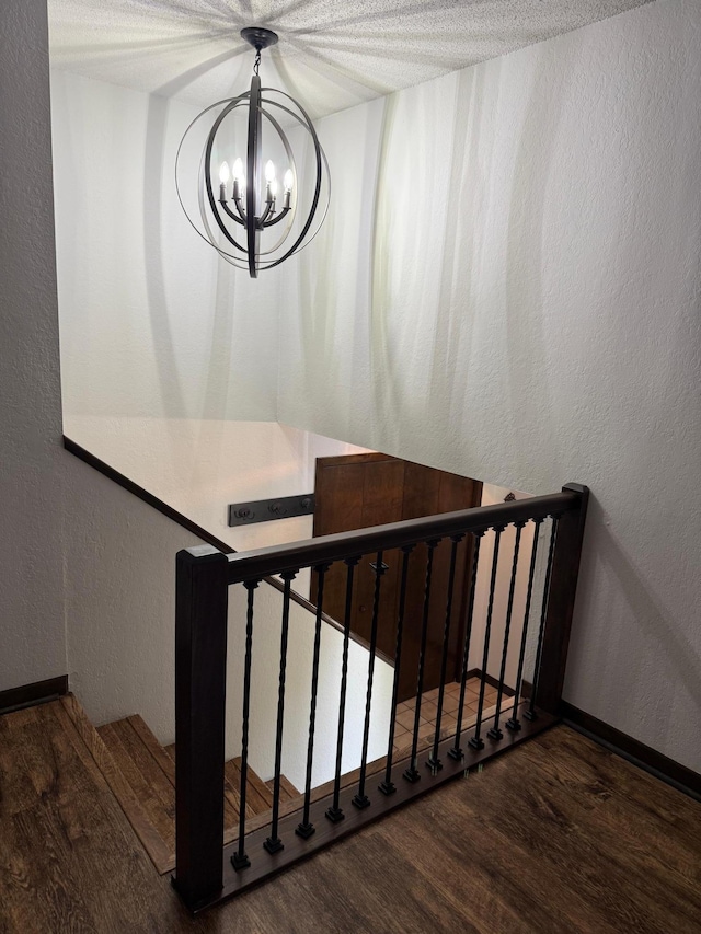 504 Fallwood Rd, Redwood Falls, MN 56283 - stairway with wood finished floors, a chandelier, and a textured wall