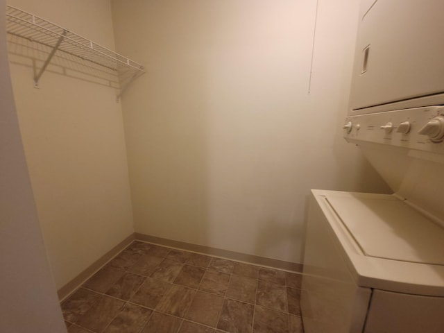 walk in closet featuring stacked washer / dryer
