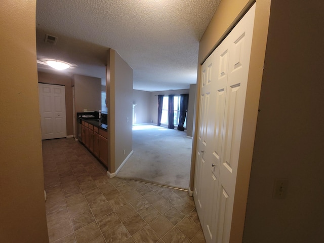 corridor featuring a textured ceiling