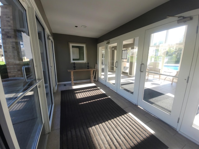 balcony with french doors and view of pool area