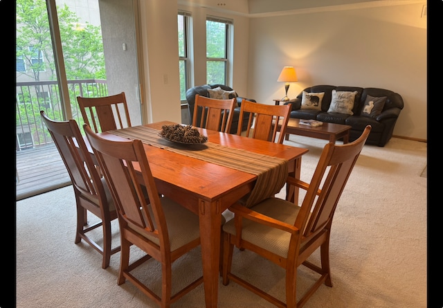 dining room with light colored carpet