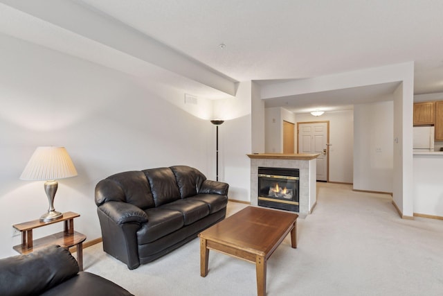 living room featuring light carpet, baseboards, and a fireplace