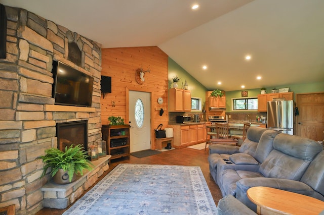 21097 Gilmer Rd, Crosby, MN 56441 - living room featuring lofted ceiling, wood walls, recessed lighting, and a stone fireplace