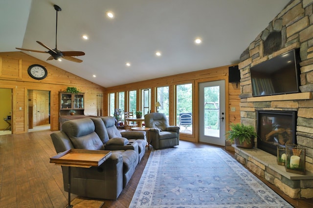 21097 Gilmer Rd, Crosby, MN 56441 - living area with wood walls, a fireplace, hardwood / wood-style floors, a ceiling fan, and high vaulted ceiling