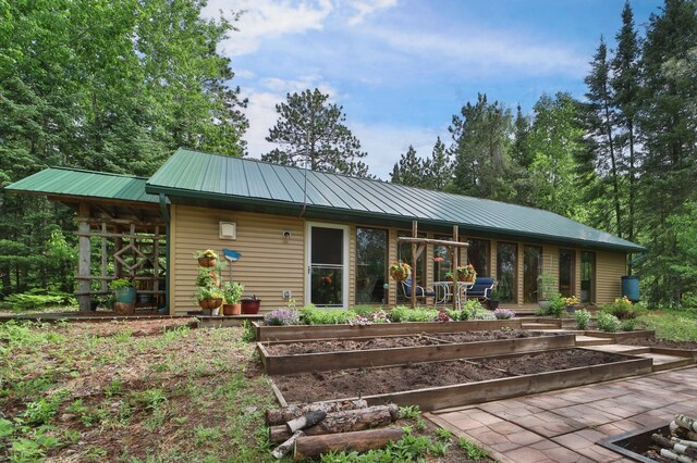 21097 Gilmer Rd, Crosby, MN 56441 - back of property with a vegetable garden and metal roof