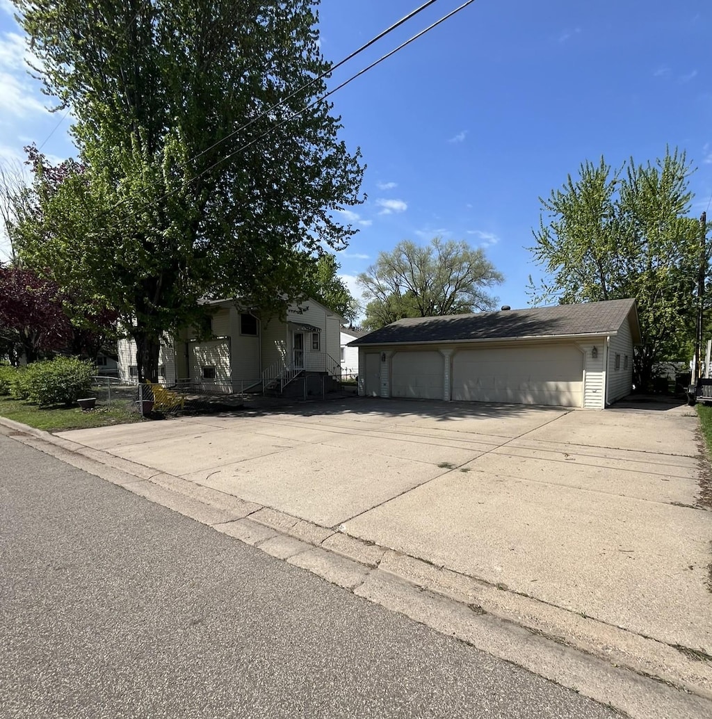 view of property exterior featuring an outbuilding and a detached garage