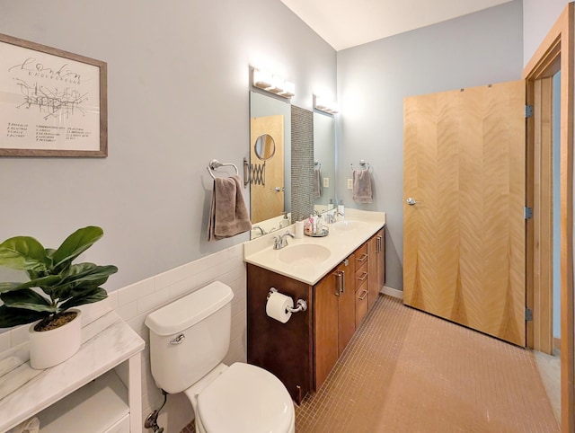 521 2nd St SE Unit 206, Minneapolis, MN 55414 - full bathroom featuring toilet, double vanity, wainscoting, and tile patterned flooring