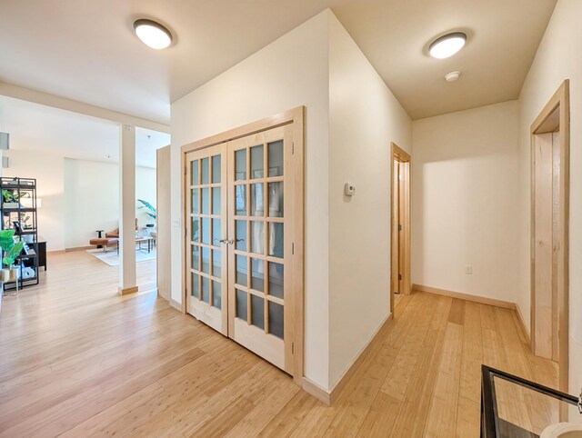 521 2nd St SE Unit 206, Minneapolis, MN 55414 - hallway featuring light wood-type flooring, french doors, and baseboards