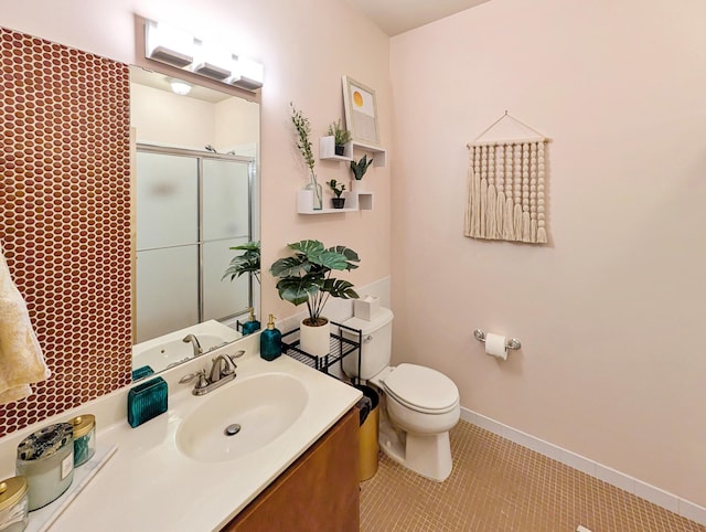 521 2nd St SE Unit 206, Minneapolis, MN 55414 - bathroom featuring a stall shower, vanity, tile patterned floors, and toilet