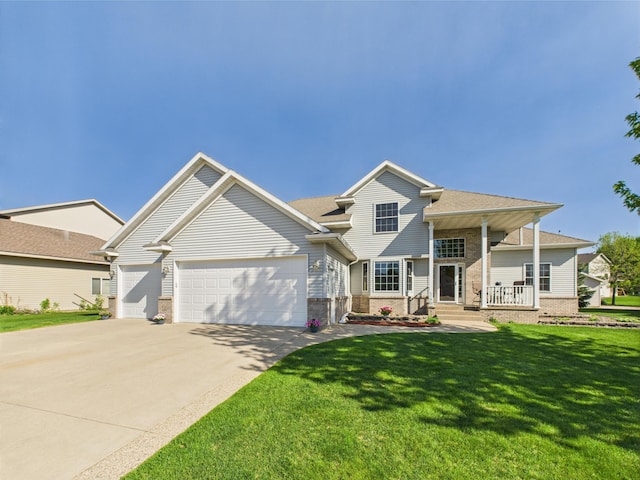 view of front of house featuring a garage, brick siding, concrete driveway, a front yard, and a porch