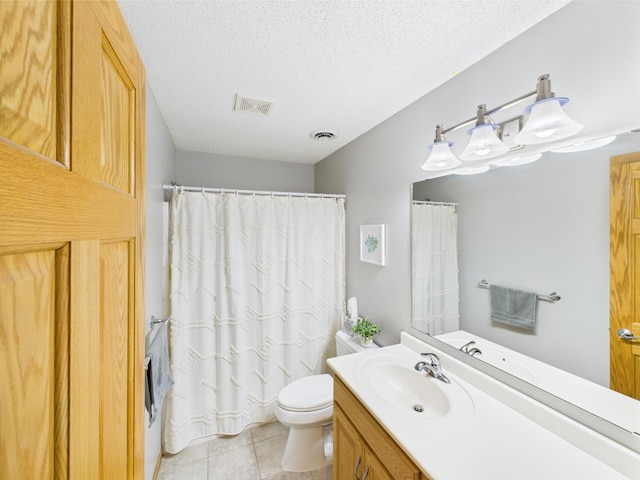 bathroom with toilet, vanity, a textured ceiling, tile patterned floors, and a shower with curtain