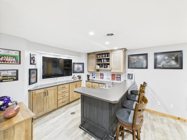 indoor wet bar featuring light wood-type flooring, recessed lighting, and baseboards