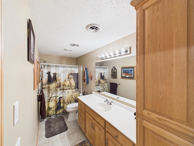 bathroom with toilet, vanity, a textured ceiling, tile patterned floors, and curtained shower