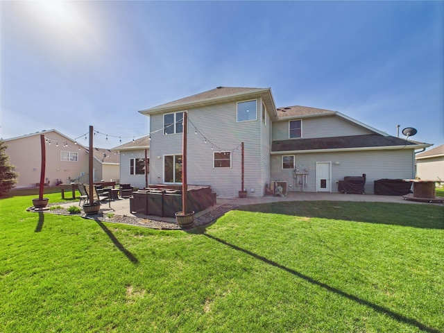 back of property featuring a patio, a lawn, and a hot tub