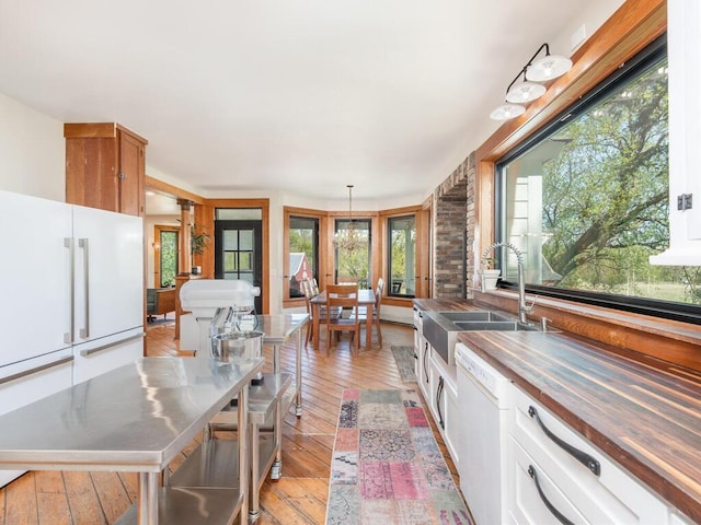 41218 Nelson Rd, North Branch, MN 55056 - kitchen featuring stainless steel countertops, a sink, light wood-type flooring, and white appliances