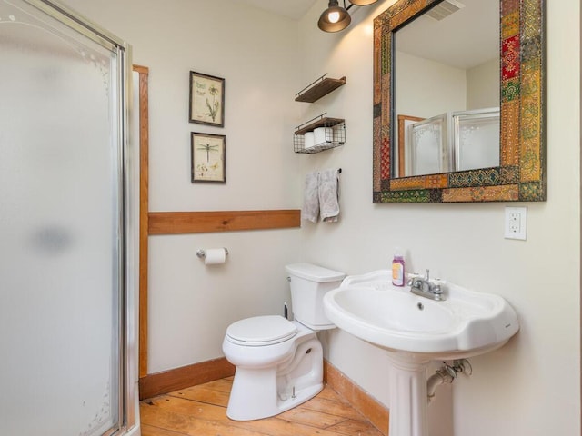 41218 Nelson Rd, North Branch, MN 55056 - bathroom with a shower stall, wood-type flooring, toilet, and baseboards