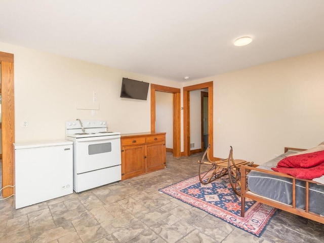 41218 Nelson Rd, North Branch, MN 55056 - kitchen featuring electric stove, fridge, stone finish floors, light countertops, and brown cabinetry