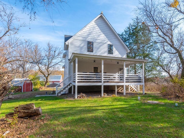 41218 Nelson Rd, North Branch, MN 55056 - view of front of house with stairway, a front yard, a storage unit, and an outdoor structure