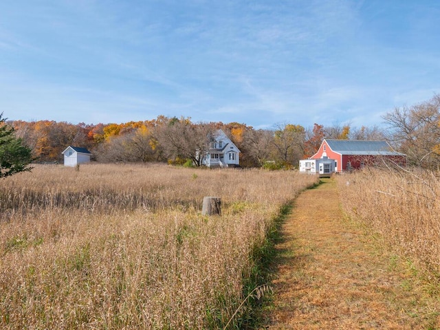 41218 Nelson Rd, North Branch, MN 55056 - view of yard featuring an outdoor structure, a storage unit, and a rural view
