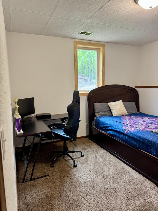 1123 Tyler Ave SE, Bemidji Twp, MN 56601 - carpeted bedroom featuring a drop ceiling, an office area, and baseboards