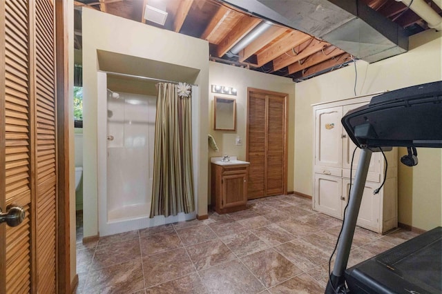 19800 See Gull Rd, Brainerd, MN 56401 - full bathroom featuring a closet, a stall shower, vanity, baseboards, and stone finish flooring